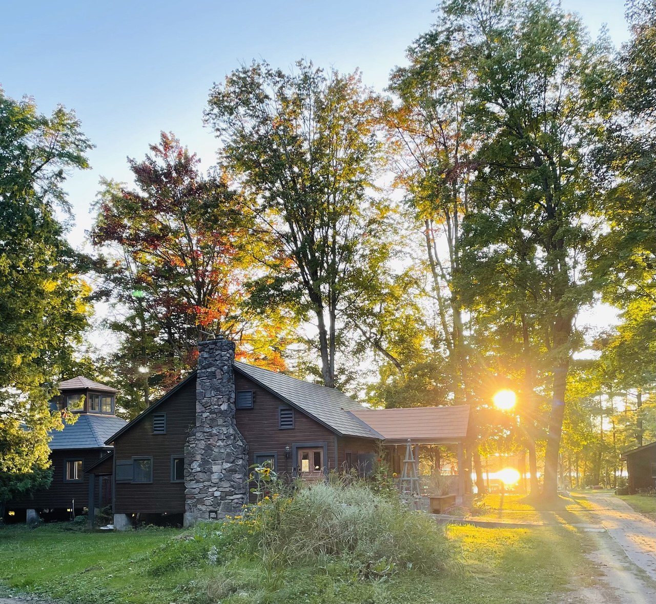 The lodge at dusk, framed by autumn trees