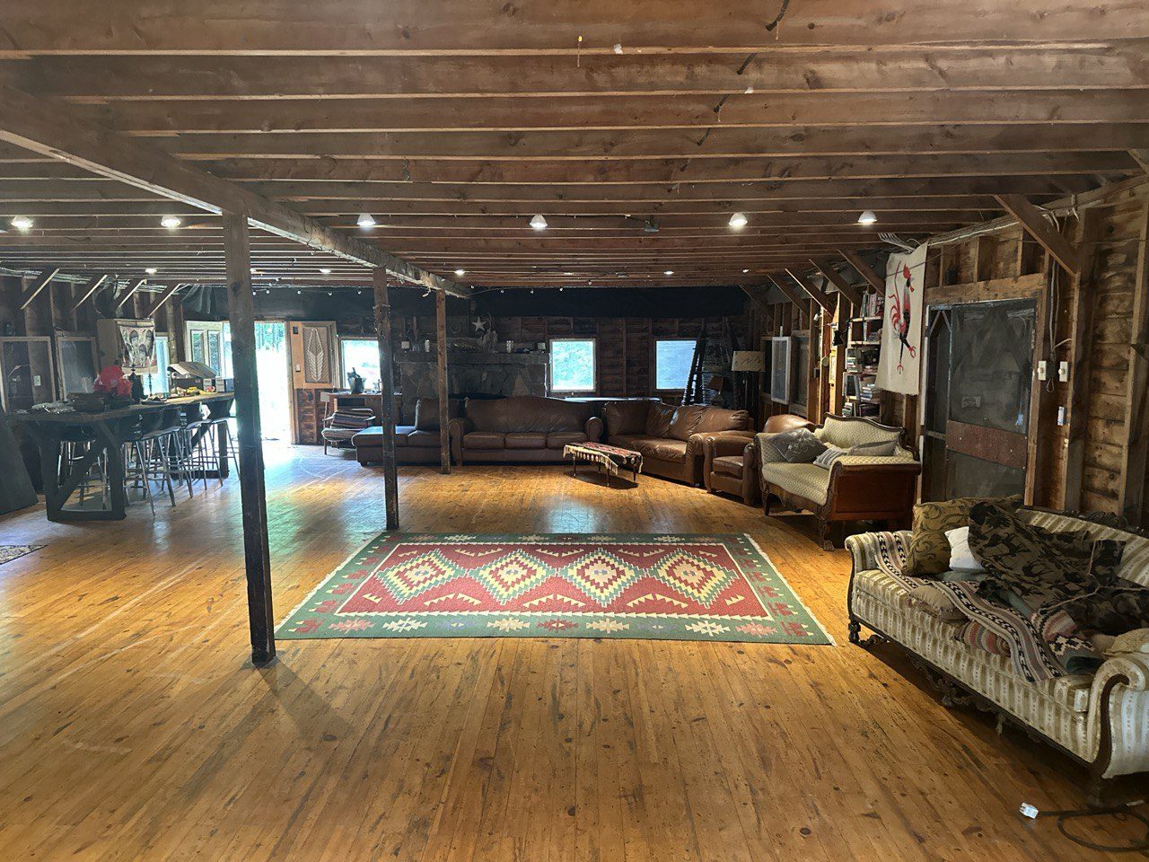 Inside the lodge — exposed beams, hardwood floors, open seating